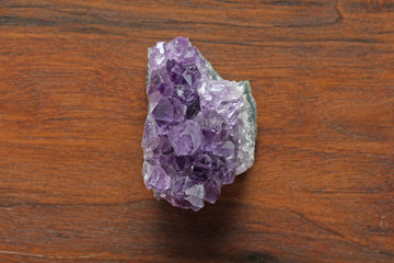 Amethyst stone. Natural Amethyst stones of minerals on a background of natural wood American black...