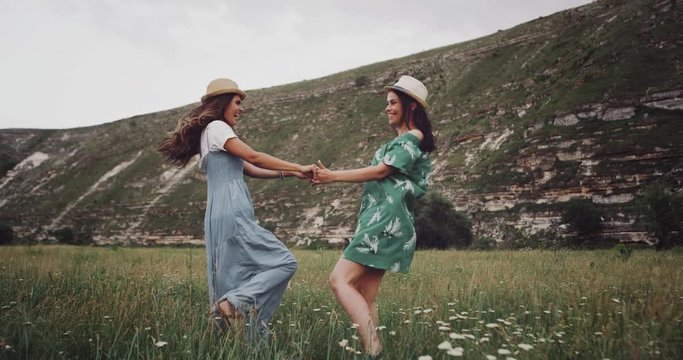 Two pretty girls have a fun time in the middle of nature.