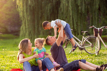 Happy family time- Young family with children having fun in nature.