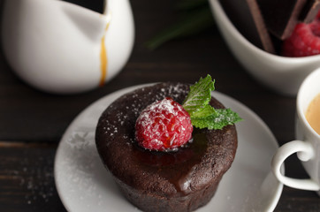 Coulant or Chocolate fondant with raspberry, mint  and powdered sugar. Delicious french dessert