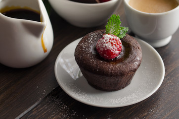 Coulant or Chocolate fondant with raspberry, mint  and powdered sugar. Delicious french dessert