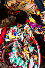 Vertical image of colorful fabric pieces for the making of Abayomi dolls. No people.