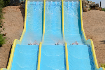 people ride water slides in the water park