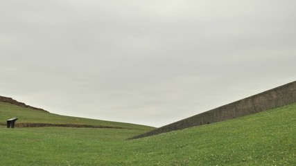 4 k green field view, abstract horizont, loneliness, dramatic sky with gray clouds