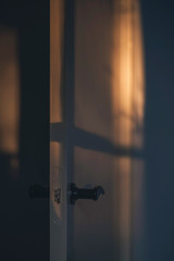 Opened interior door in evening sunlight.