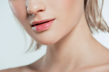 Obraz premium cropped view of female face, isolated on grey