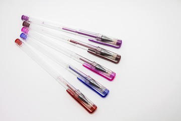 Gel pens multicolored on white background isolated.