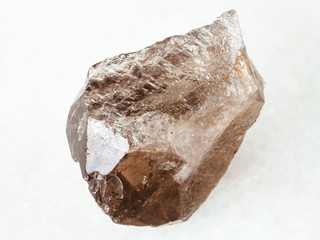 rough smoky quartz crystal on white