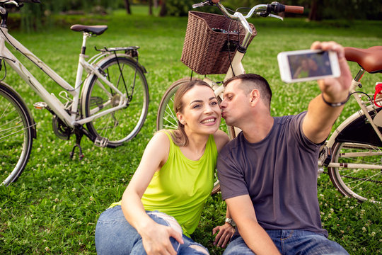 love, technology, relationship, family and people concept - young couple taking selfie.