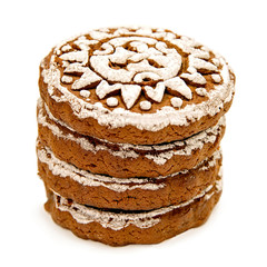pile of gingerbread with white glazing in sun shape isolated on white with clipping path