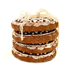pile of gingerbread with white glazing in sun shape with a thread isolated on white with clipping path