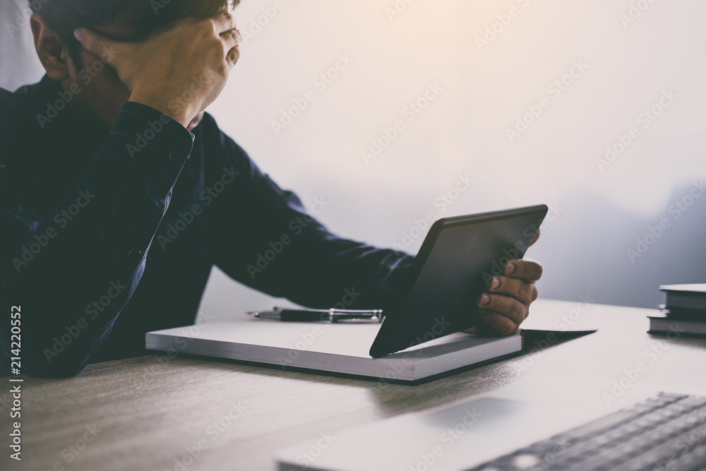 Poster stress at work, businessman using tablet working analysis investment connection at modern workplace