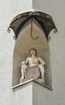 Maribor, Slovenia - May 22, 2018: Statue of Dionysus in the corner niche of the former Hotel Orel on Slovenska street, under a baldachin, Maribor, Slovenia