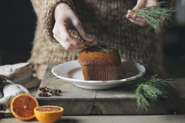 Woman's hands decorating Christmas cake