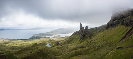 A path to the Old Man of Storr on the Isle of Skye with a sea in the background during a cloudy summer day in Scotland