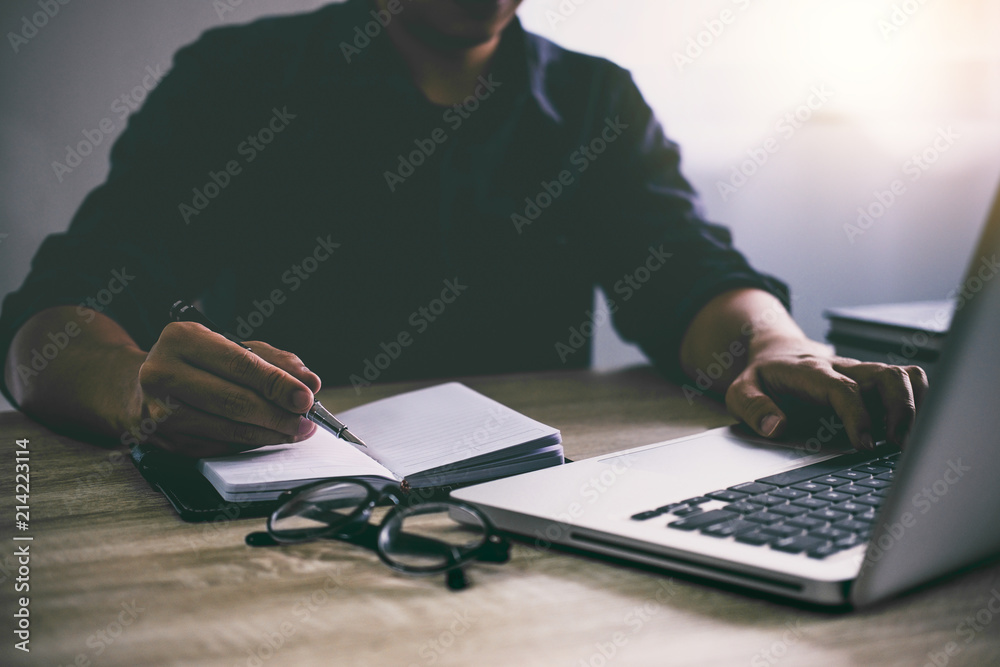 Poster professional at work, businessman writing report and using laptop working analysis investment connec