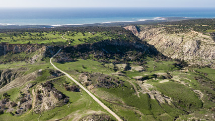 Fototapeta na wymiar aerial view of green valley with lonely road to sea, Israel