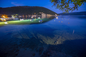 Fototapeta premium Desimi Beach Golf and nearby Island with clear water in Greece