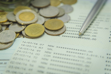 Closeup  various of coins on saving account passbook
