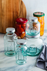 Glass jars, ready for sterilization and canning. preservation of food on a marble table.