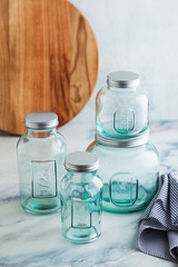 Glass jars, ready for sterilization and canning. preservation of food on a marble table.