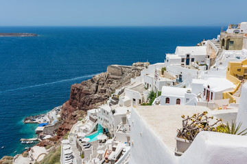 Tiny little white houses, hotels and small churches in the Oia village at Santorini, Greece.