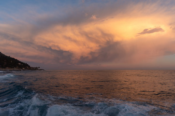 Fototapeta na wymiar Stormy clouds of contrasting color over sea