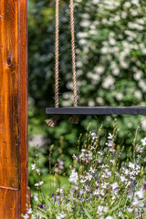 Wooden Swing In Summer Garden