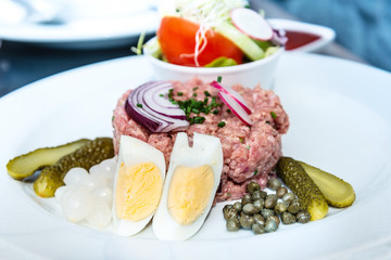 tasty Steak tartare (Raw beef) - classic steak tartare on white plate