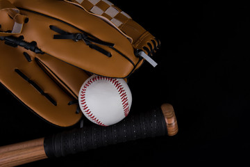 Baseball bat, ball and glove on black