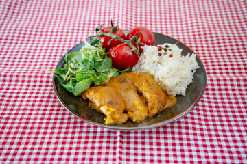 Rice and chicken on dark plate