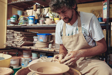 Creating a jar or vase of white clay close-up. Master crock.