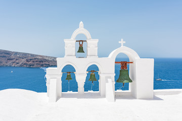 Green bells on roof of the church in the Oia village at Santorini, Greece.