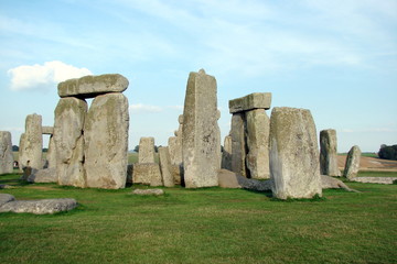 Stonehenge in Hampshire on the background of a cloudy blue sky on a warm summer day at sunset.