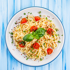 Pasta with vegetables on wooden table
