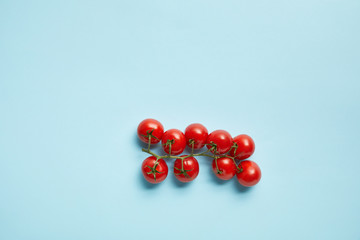 top view of fresh cherry tomatoes isolated on blue