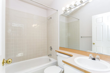 Renovated interior of a white bathroom.