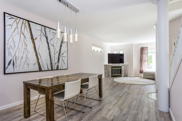 Modern dining area with a wooden table and leather chairs.