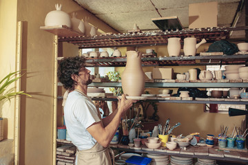 Creating a jar or vase of white clay close-up. Master crock.