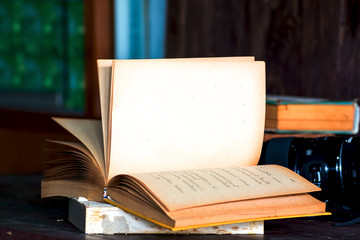 Fototapeta premium Old book wooden library desk, retro toned image, selective focus