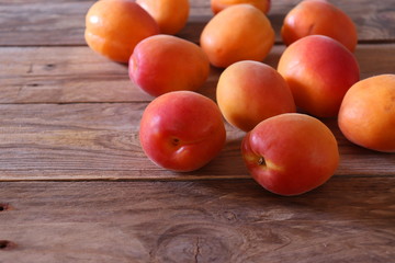 Fresh apricots on wooden surface