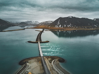 Aerial view of road 1 in iceland with bridge over the sea in Snaefellsnes peninsula with clouds,...
