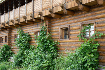 Fototapeta na wymiar Facade of a log wall with windows. Russian architecture