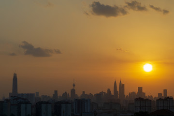 Majestic sunset over KL Tower and surrounded buildings in downtown Kuala Lumpur, Malaysia.