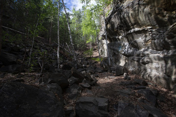 Obraz premium Abandoned ore mica mine quarry open pit in forest