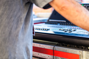 Man using mixing console and other music equipment