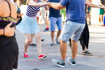 Group of people dancing swing outdoors