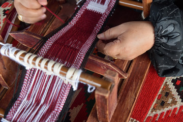 Hands of an arabian female weaver