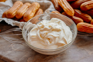 Homemade eclairs. Preparation of eclairs in the home kitchen. The process of cooking eclairs.Eclair a small, soft, log-shaped pastry filled with cream and typically topped with chocolate icing.