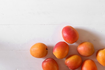 Fresh apricots on white surface